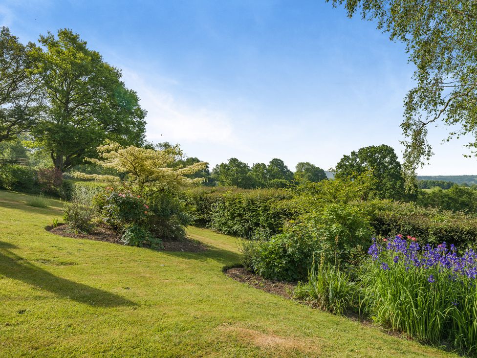 A garden with trees and flowers at Underhill House