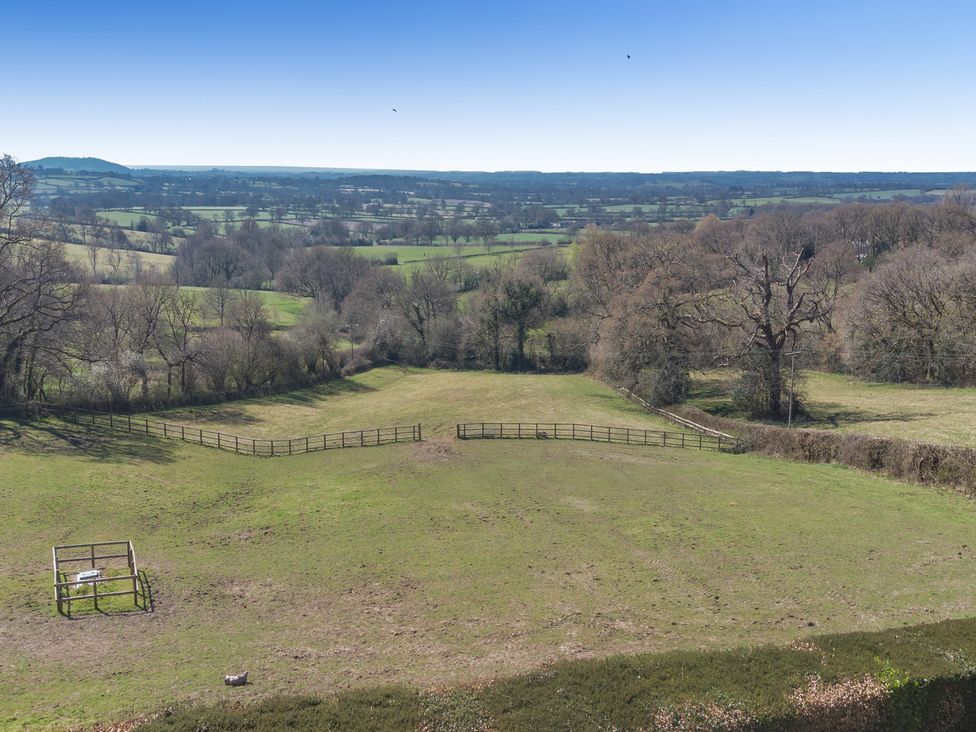A field with trees and a wooden structure at Underhill House