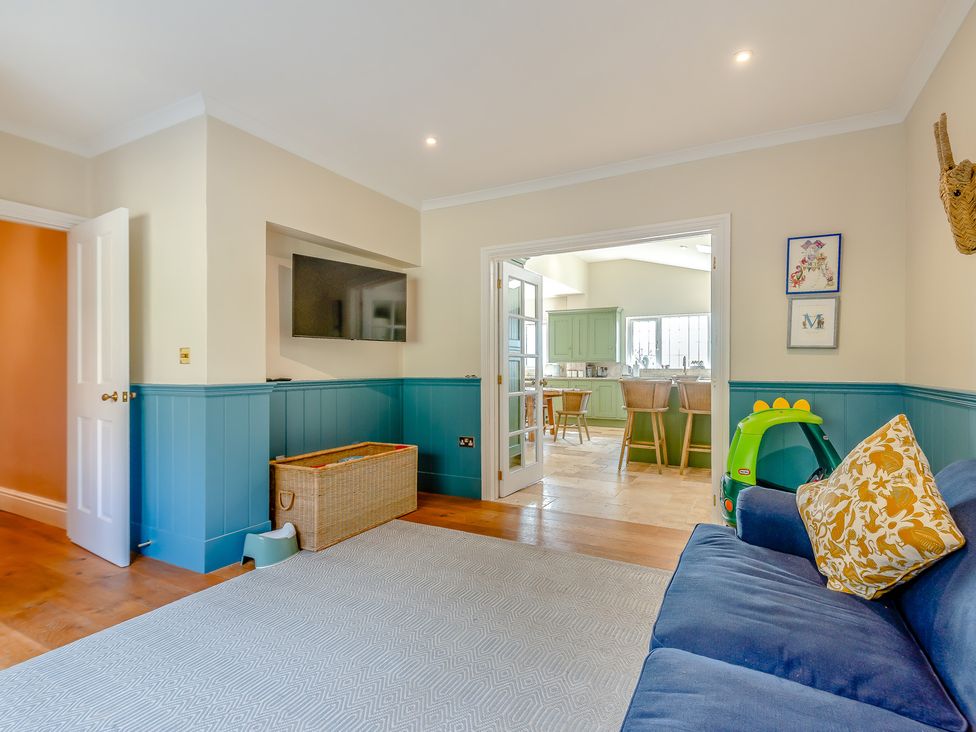 A living room with a sofa and television at Underhill House