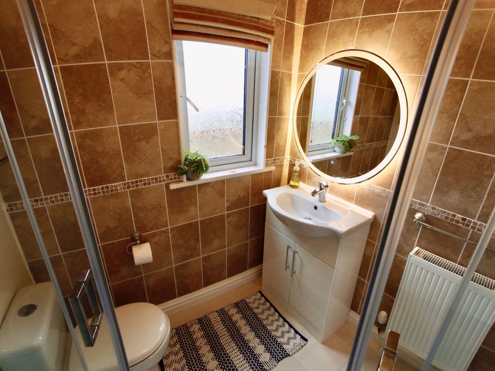 A bathroom with a sink and toilet at Lowena Lodge Whitsand Bay Holiday Park near Millbrook