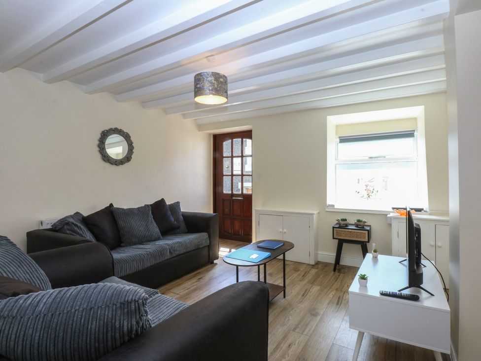 A living room with a sofa and television at 3 York Place Conwy