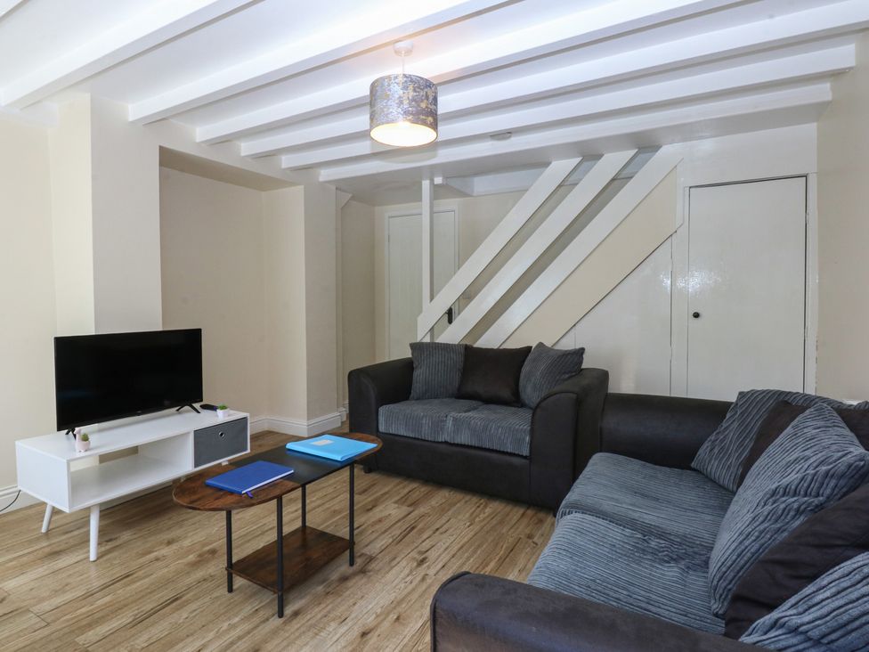 A living room with a sofa and television at 3 York Place, Conwy