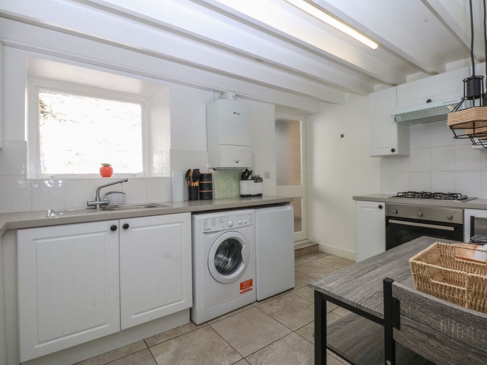 A kitchen with a sink and washing machine at 3 York Place Conwy