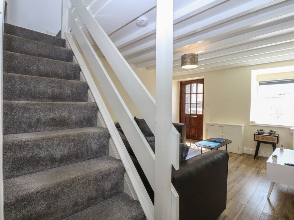 A living room with a staircase and sofa at 3 York Place in Conwy