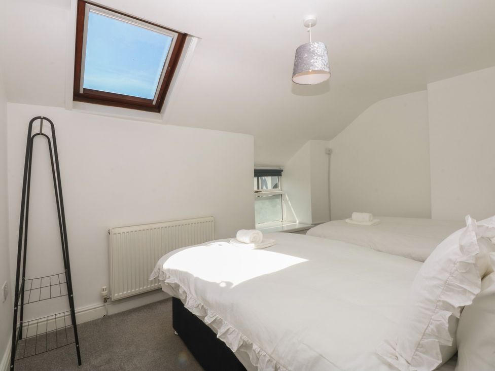 A bedroom with two beds and a window at 3 York Place Conwy