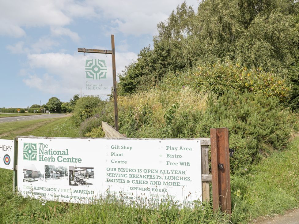 A sign for The National Herb Centre with details about services at The National Herb Centre Banbury