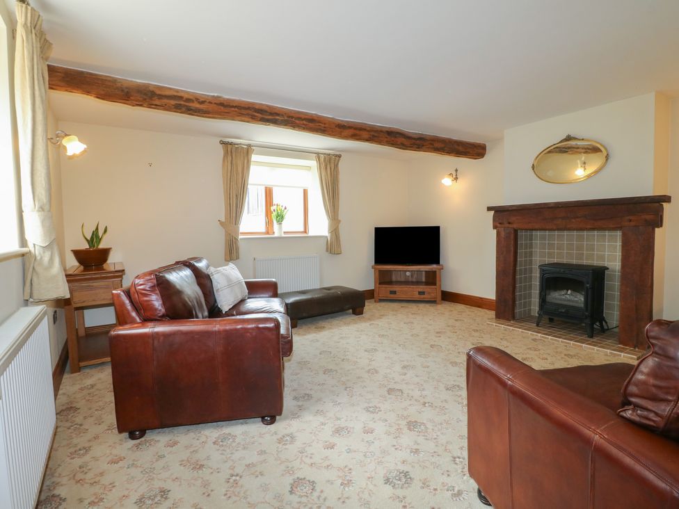 A living room with a sofa and television at Carr House Farm in Waberthwaite