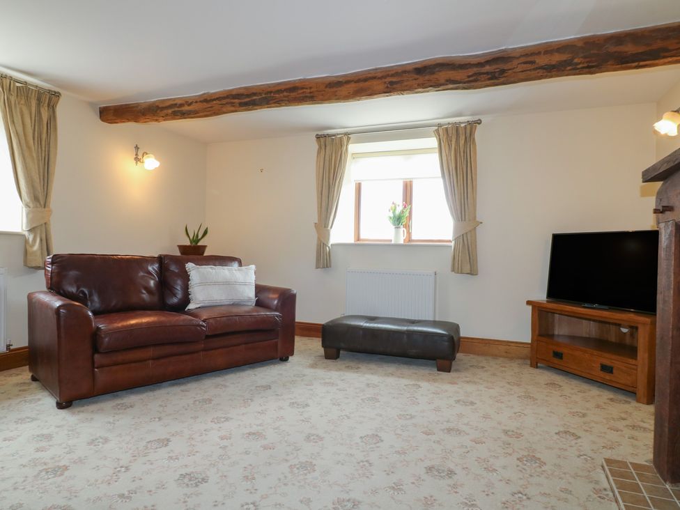 A living room with a sofa and television at Carr House Farm in Waberthwaite
