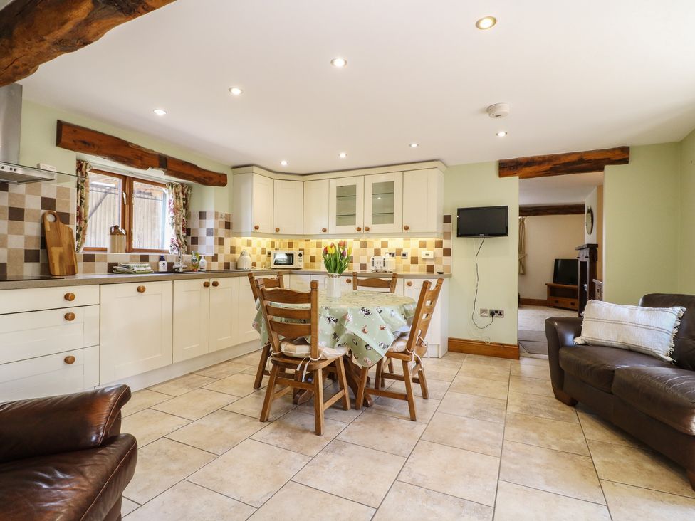 A kitchen with a table and chairs at Carr House Farm in Waberthwaite