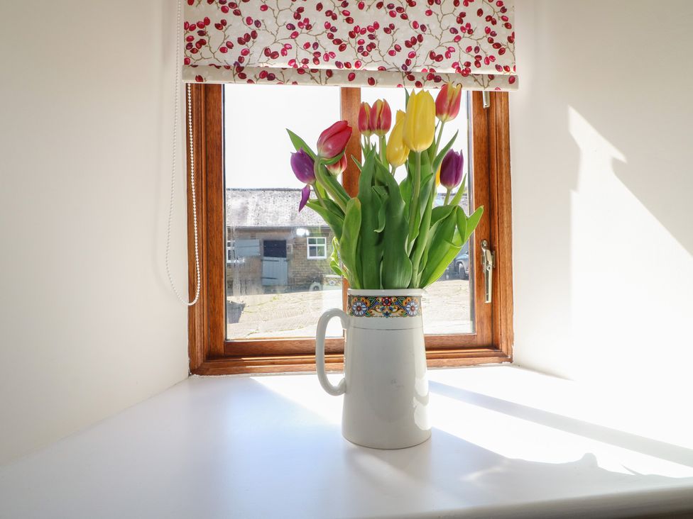 A flower vase with tulips on a windowsill at Carr House Farm in Waberthwaite