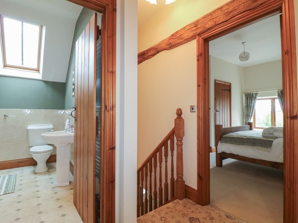 A bathroom with a sink and toilet and adjacent bedrooms at Carr House Farm Waberthwaite