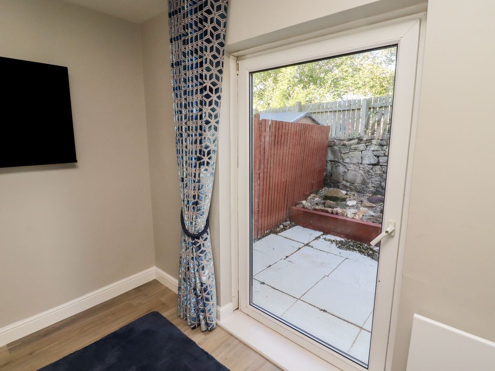 A snug with a door leading to a patio area at 3 Longstone Park Beadnell