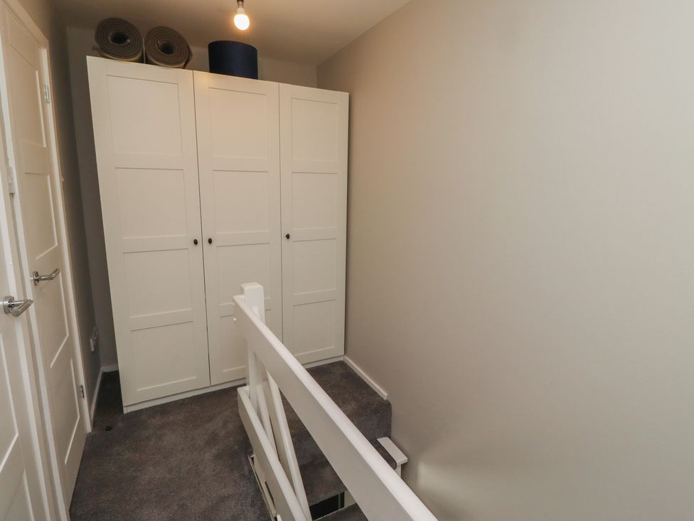 A landing area with a wardrobe and stairs at 3 Longstone Park Beadnell