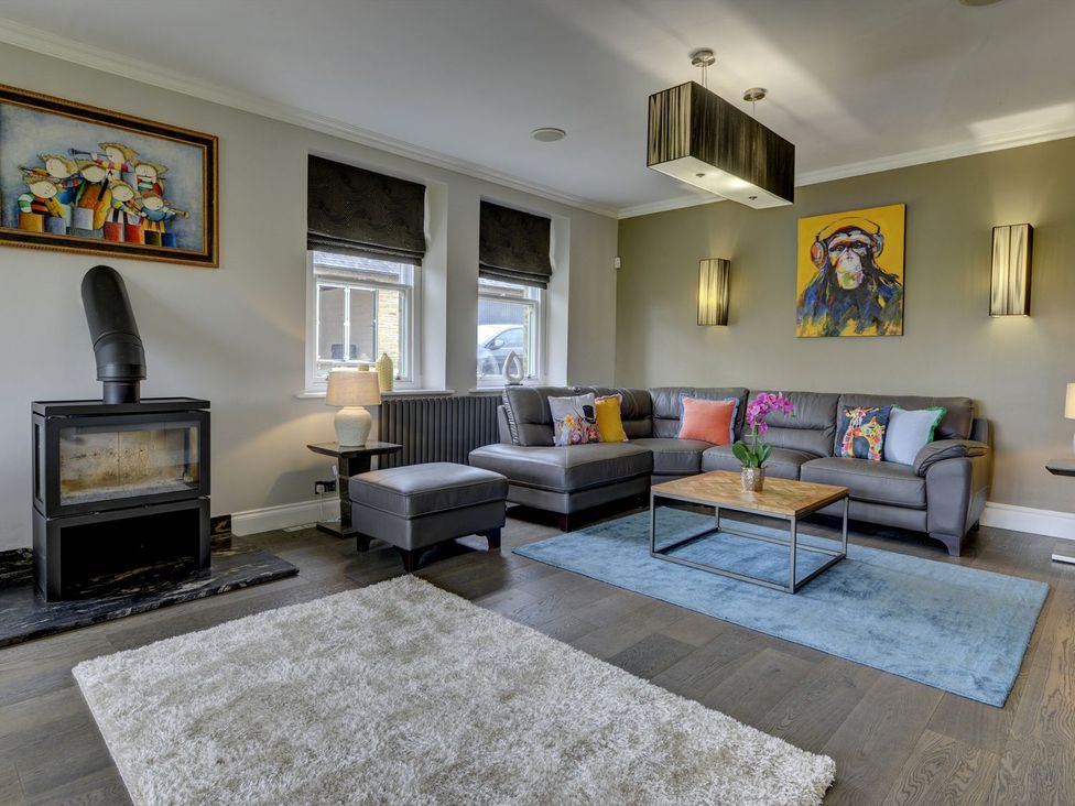 A living room with a sofa and coffee table at The Farm House in Aldbrough St. John near Barton