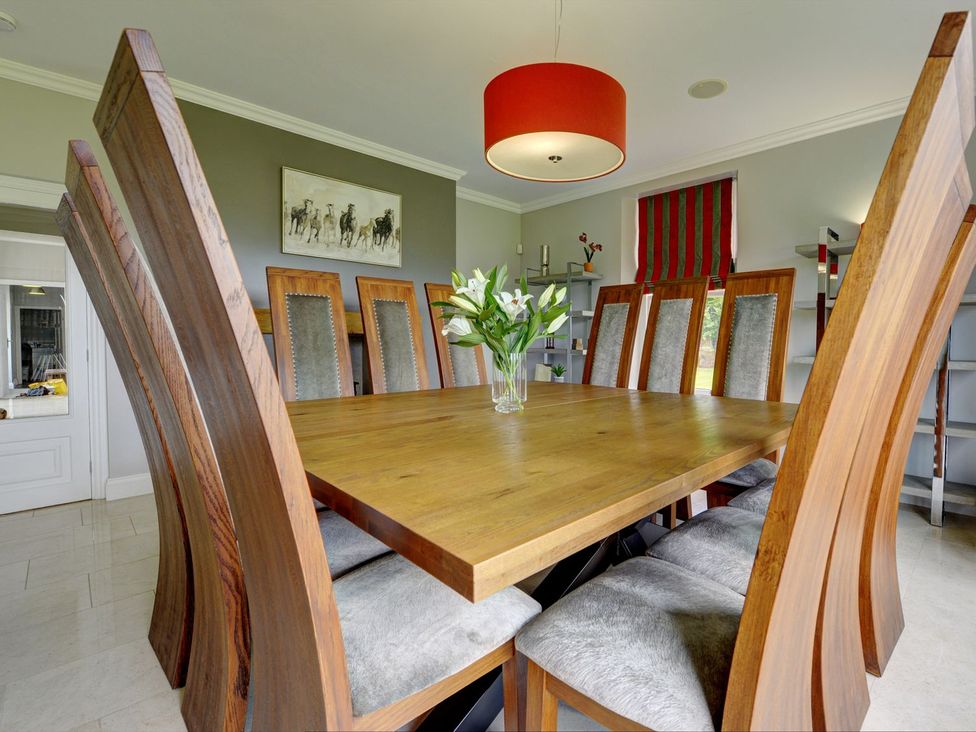 A dining room with a table and chairs at The Farm House in Aldbrough St. John near Barton