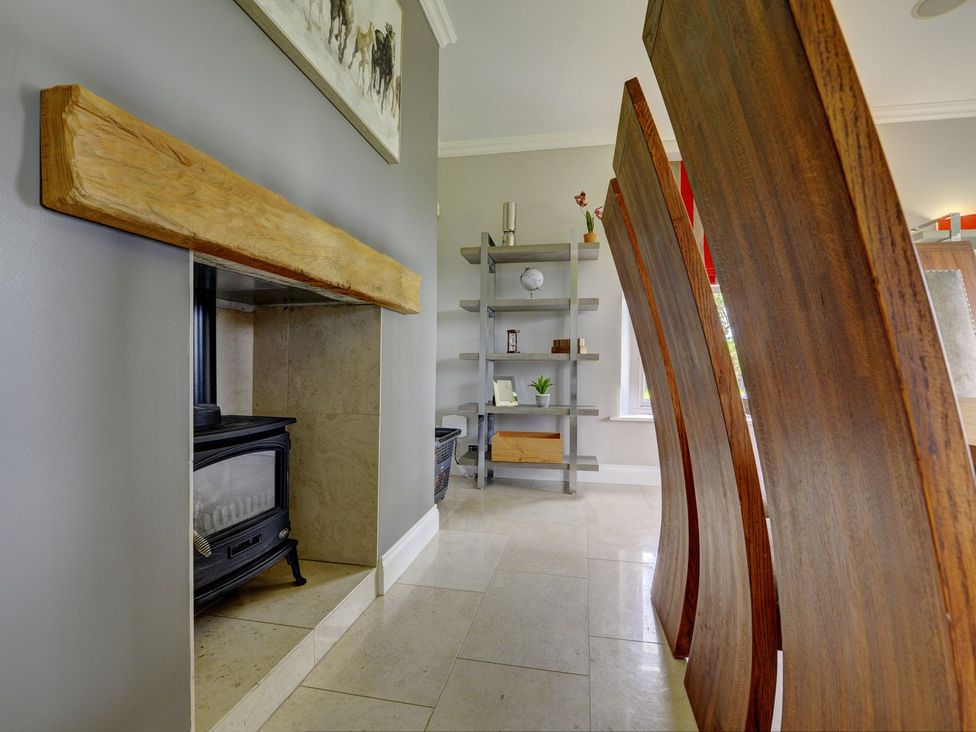 A living room with a fireplace and shelf at The Farm House near Aldbrough St. John near Barton