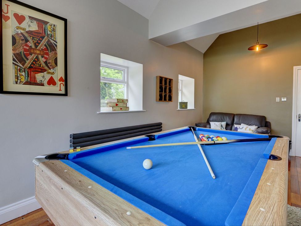 A snug with a pool table and seating area at The Farm House in Aldbrough St. John near Barton