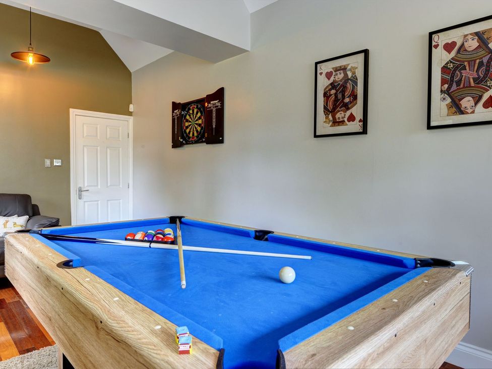A game room with a pool table and darts board at The Farm House near Aldbrough St. John