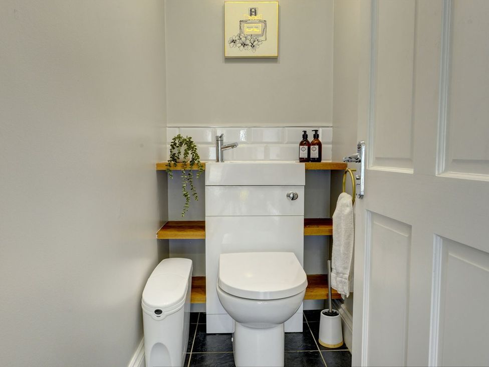A bathroom with a toilet and sink at The Farm House in Aldbrough St. John near Barton