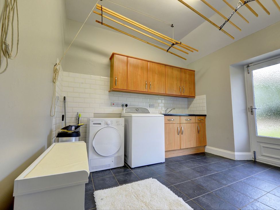 A laundry room with a washing machine and dryer at The Farm House in Aldbrough St. John near Barton