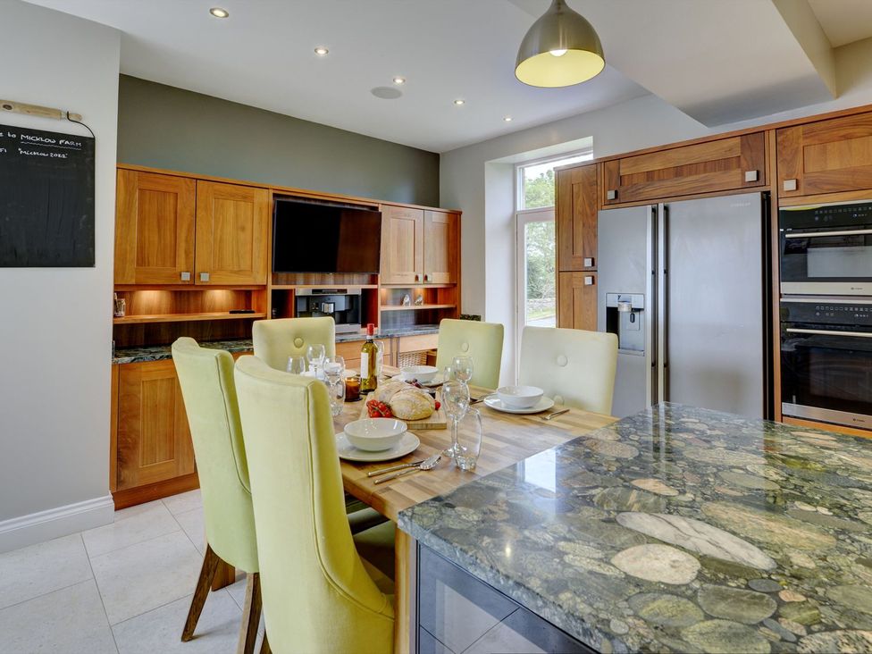 A kitchen with a table and chairs at The Farm House in Aldbrough St. John near Barton