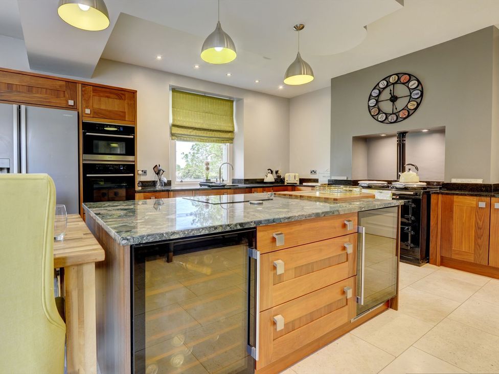 A kitchen with appliances and a large island at The Farm House in Aldbrough St. John near Barton