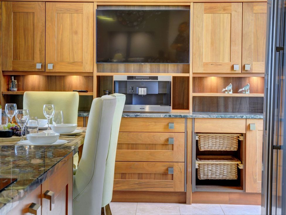 A kitchen with cabinets and a coffee machine at The Farm House near Aldbrough St. John