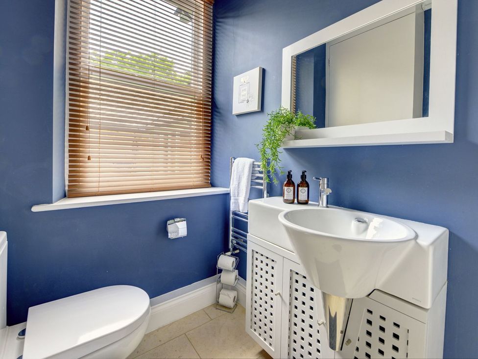 A bathroom with a sink and toilet at The Farm House in Aldbrough St. John near Barton
