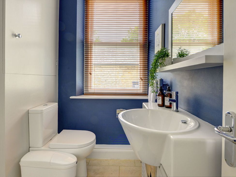 A bathroom with a sink and toilet at The Farm House in Aldbrough St. John near Barton