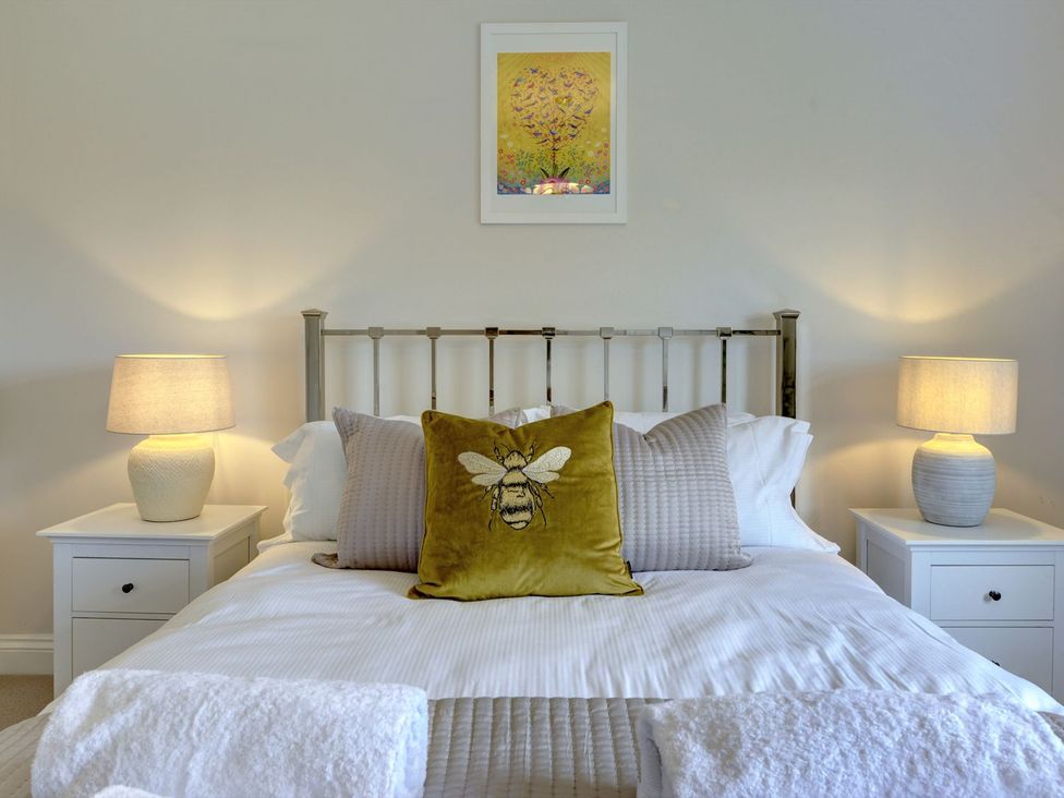 A bedroom with a bed and nightstand at The Farm House in Aldbrough St. John near Barton