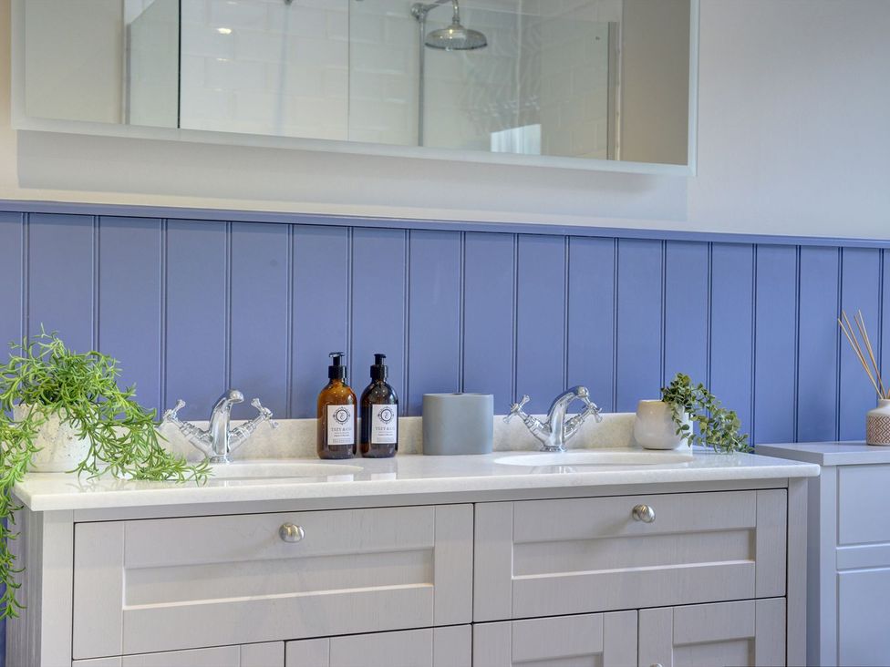 A bathroom with sink and taps at The Farm House in Aldbrough St. John near Barton
