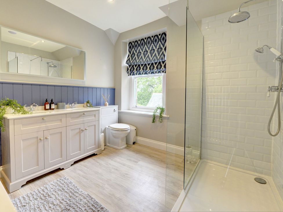 A bathroom with a shower and vanity unit at The Farm House in Aldbrough St. John near Barton