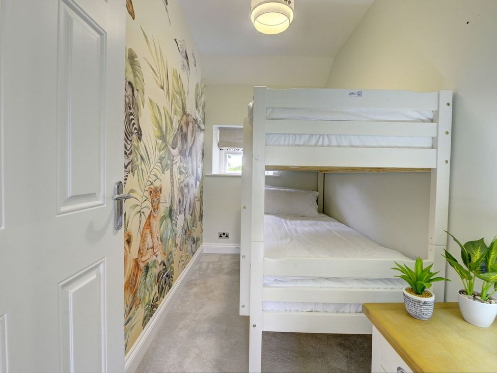 A bedroom with a bunk bed and wall mural at The Farm House near Aldbrough St. John