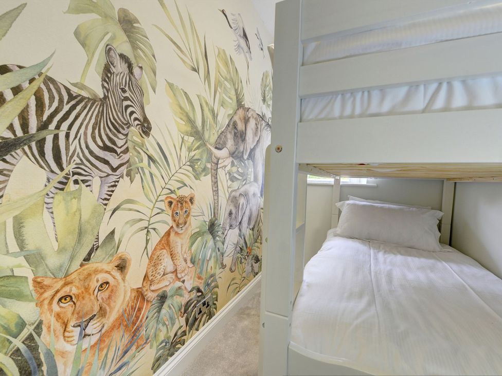 A bedroom with a bunk bed and animal mural at The Farm House in Aldbrough St. John near Barton