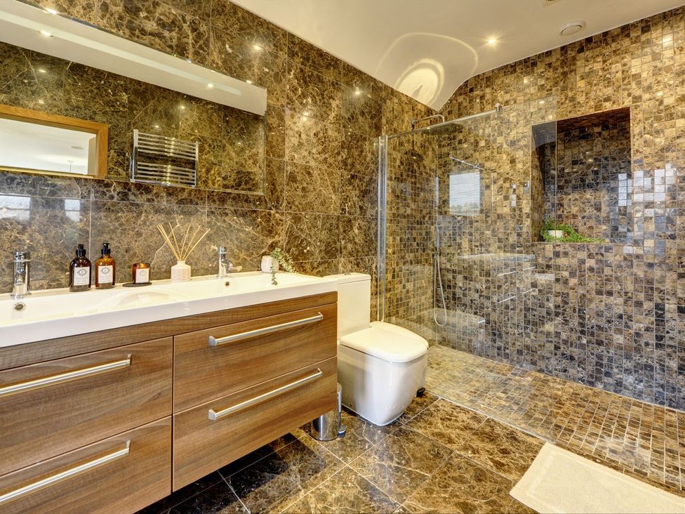 A bathroom with a shower and sink at The Farm House in Aldbrough St. John near Barton