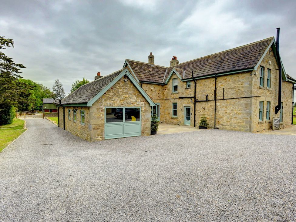 A house with gravel driveway and garden at The Farm House near Aldbrough St. John