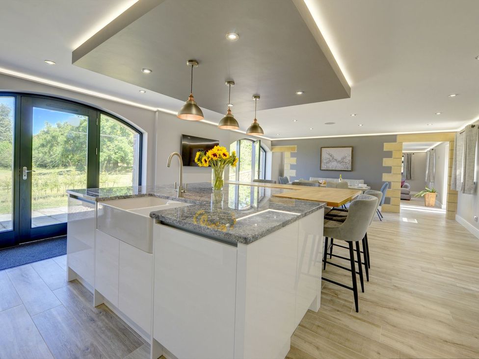 A kitchen with an island and dining area at The Gate House near Aldbrough St. John