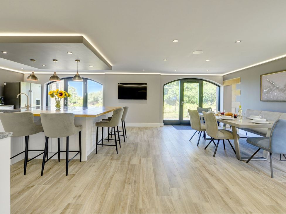 A kitchen with an island and dining area at The Gate House near Aldbrough St. John