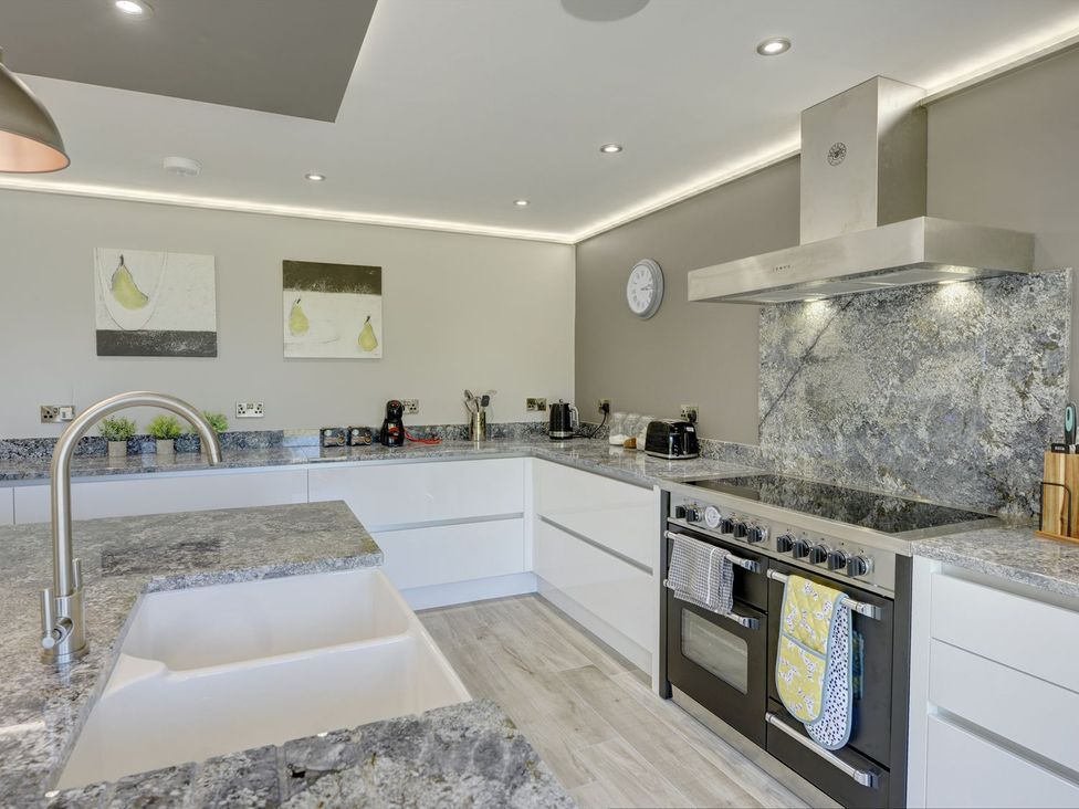 A kitchen with modern appliances and a large countertop at The Gate House Aldbrough St. John near Barton
