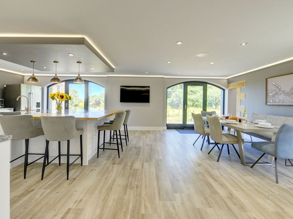A kitchen with a dining area and large windows at The Gate House in Aldbrough St. John near Barton