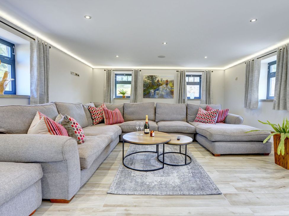 A living room with a sofa and coffee table at The Gate House in Aldbrough St. John near Barton