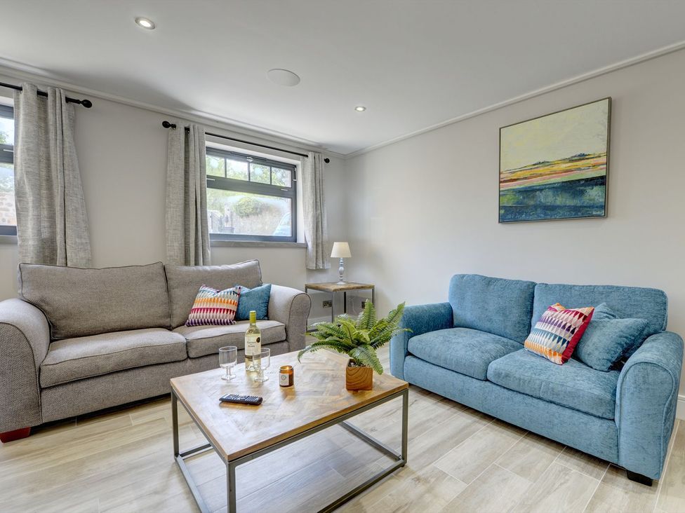A living room with sofas and a coffee table at The Gate House in Aldbrough St. John near Barton