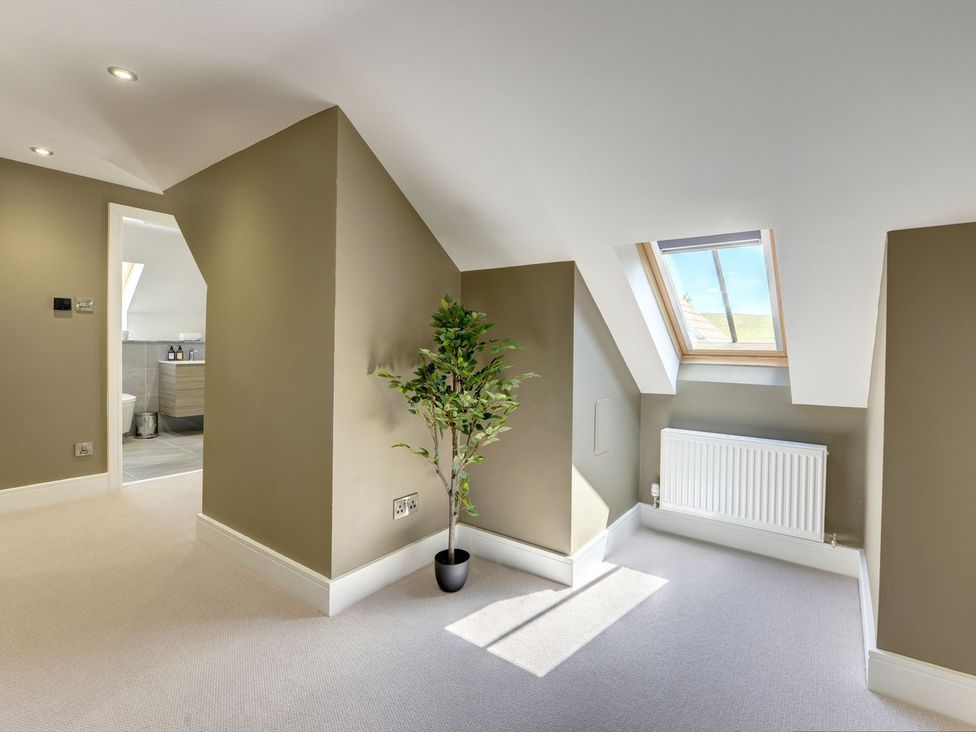 A loft with a plant and a radiator at The Gate House in Aldbrough St. John near Barton