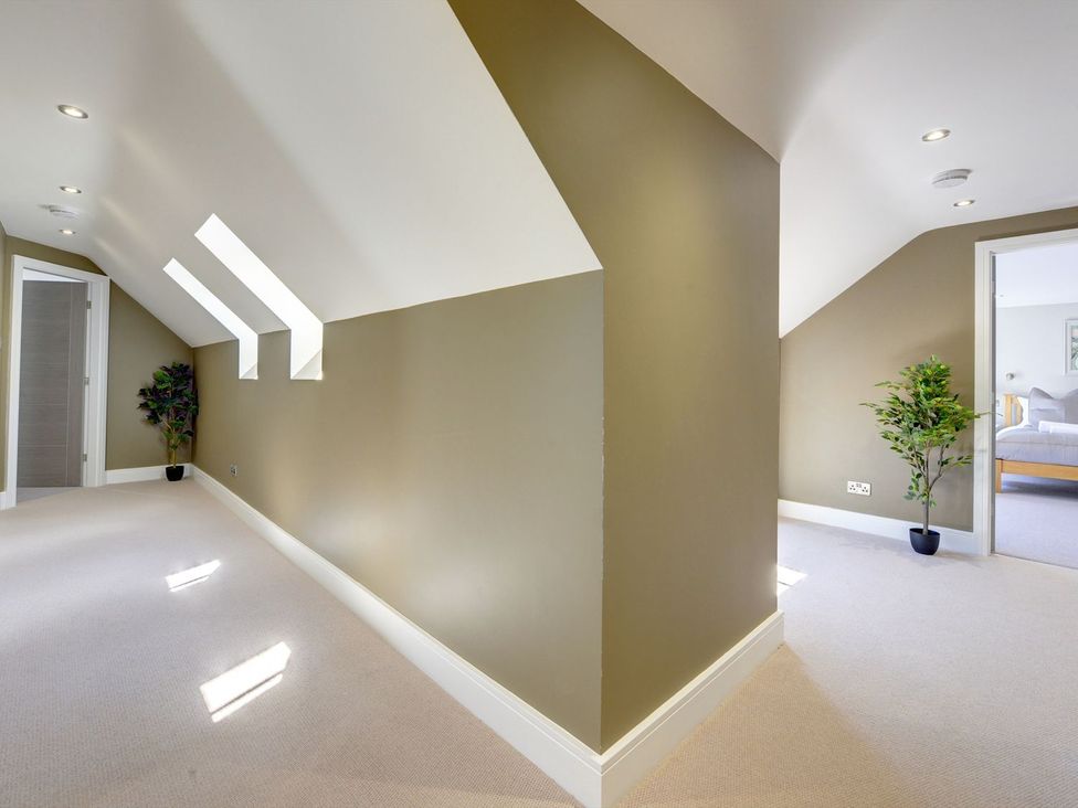 A hallway with an indoor plant and doors at The Gate House in Aldbrough St. John near Barton