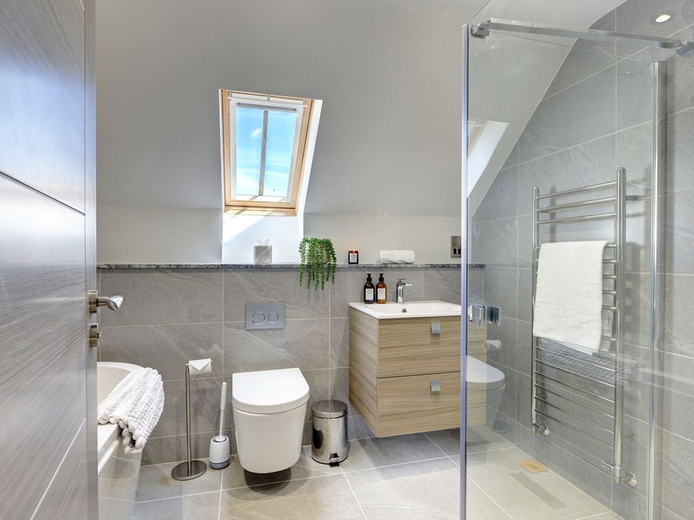 A bathroom with a sink, toilet, and shower at The Gate House in Aldbrough St. John near Barton