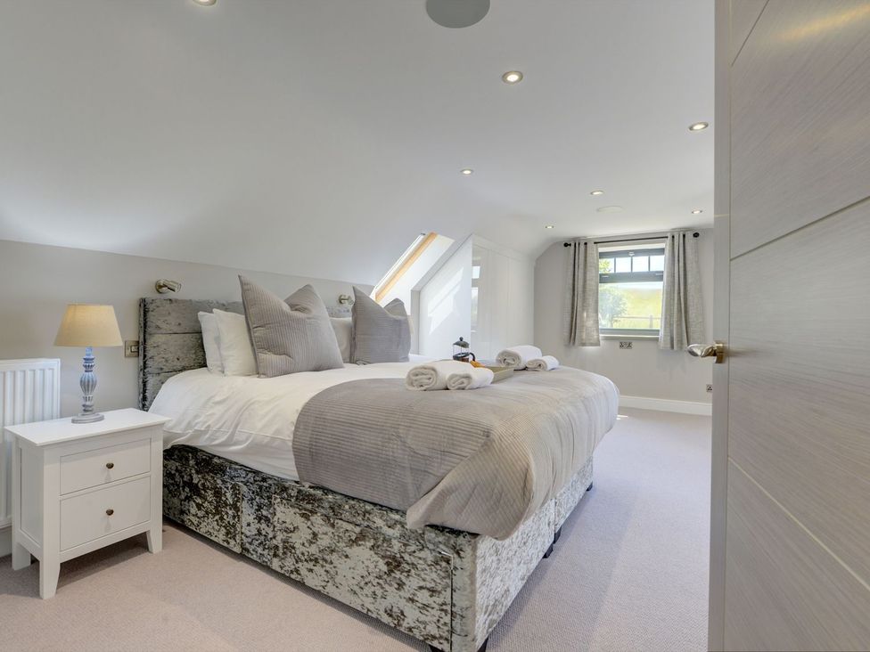 A bedroom with a bed and bedside table at The Gate House near Aldbrough St. John
