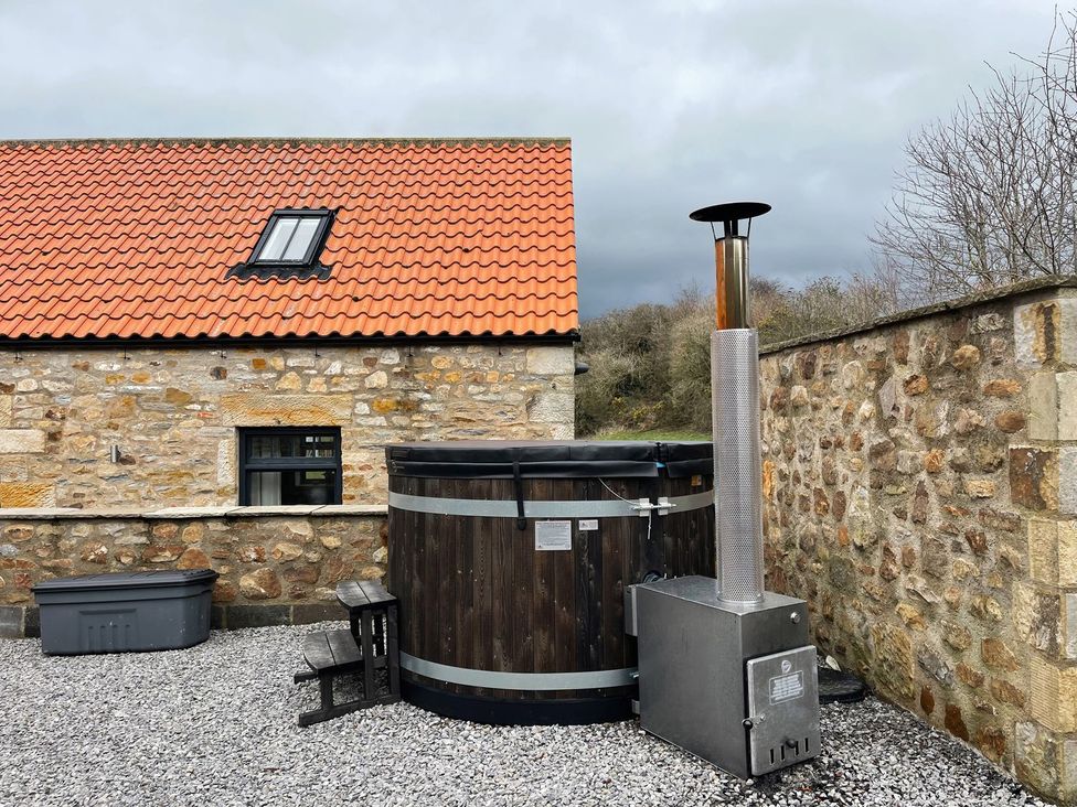 An outdoor area with a hot tub and heater at The Gate House near Aldbrough St. John