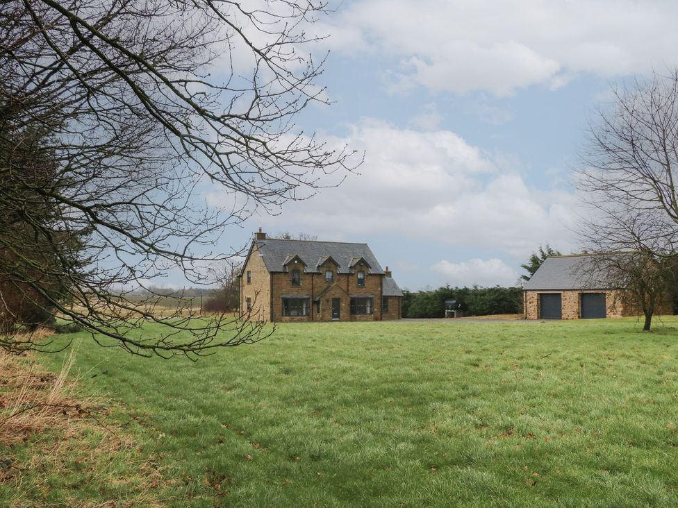 A house and garage in a grassy area at Hollymoor Hall Farm in Richmond