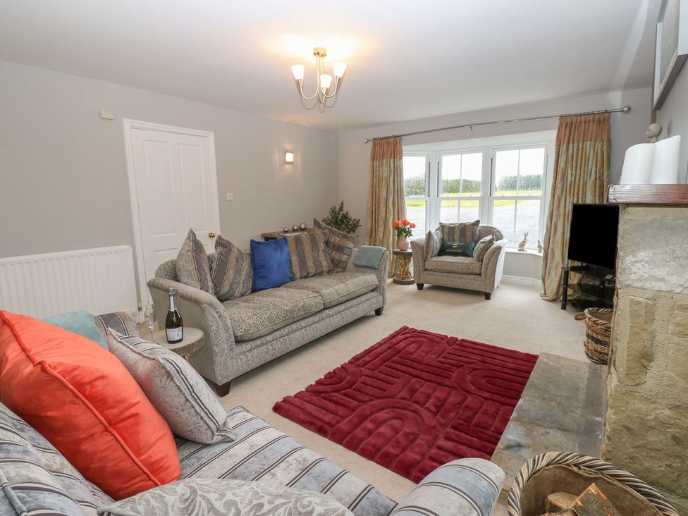 A living room with sofas and a coffee table at Hollymoor Hall Farm Richmond