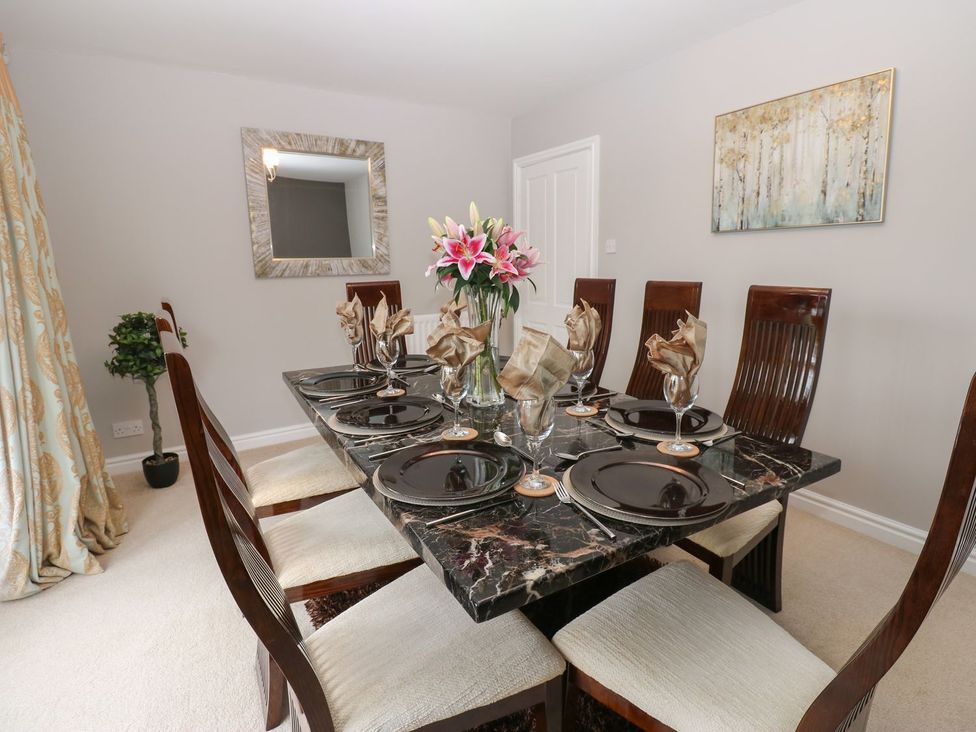 A dining room with a table set for dinner at Hollymoor Hall Farm Richmond